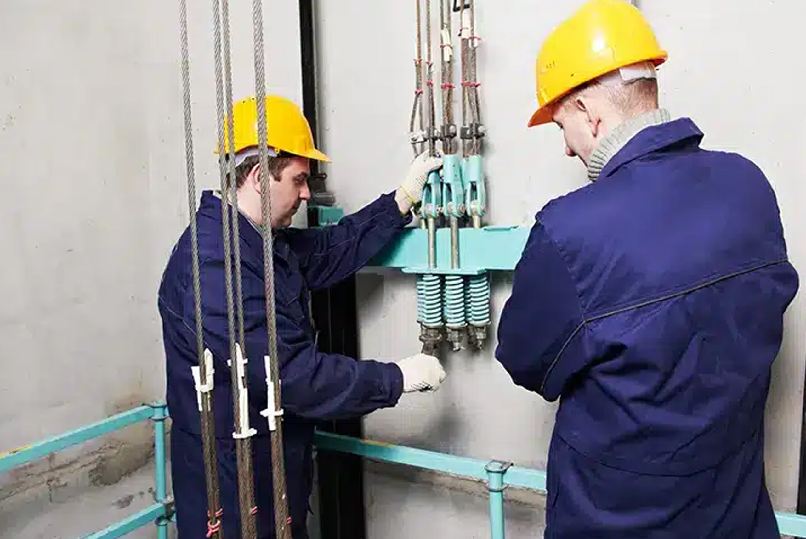 Technicians testing elevator safety devices